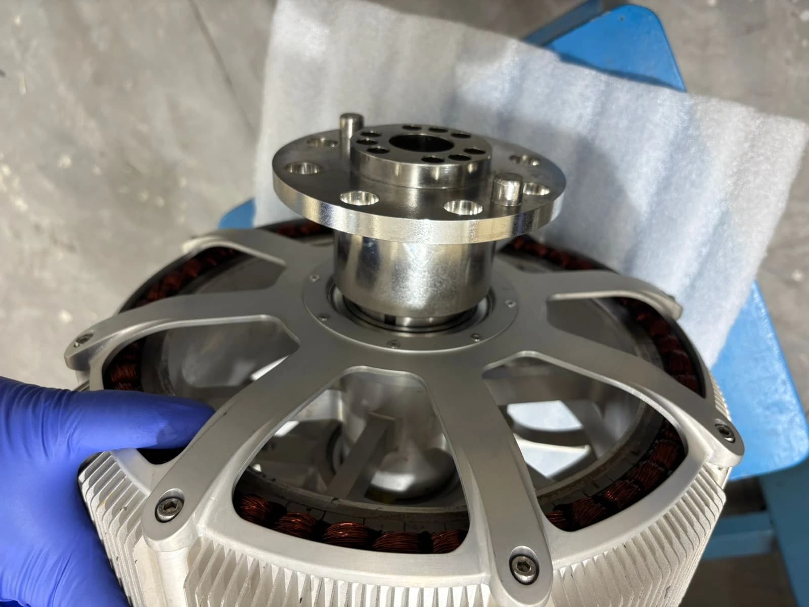 Gloved hands assembling the rotor and stator of an S R Aerospace propulsion motor